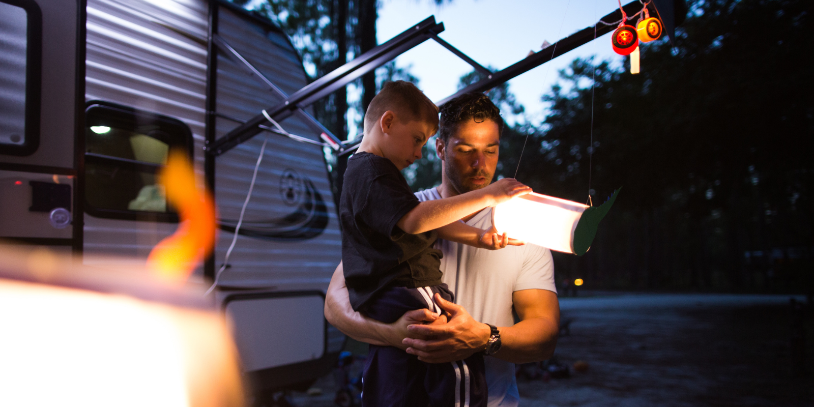 Family RV camping in woods_h