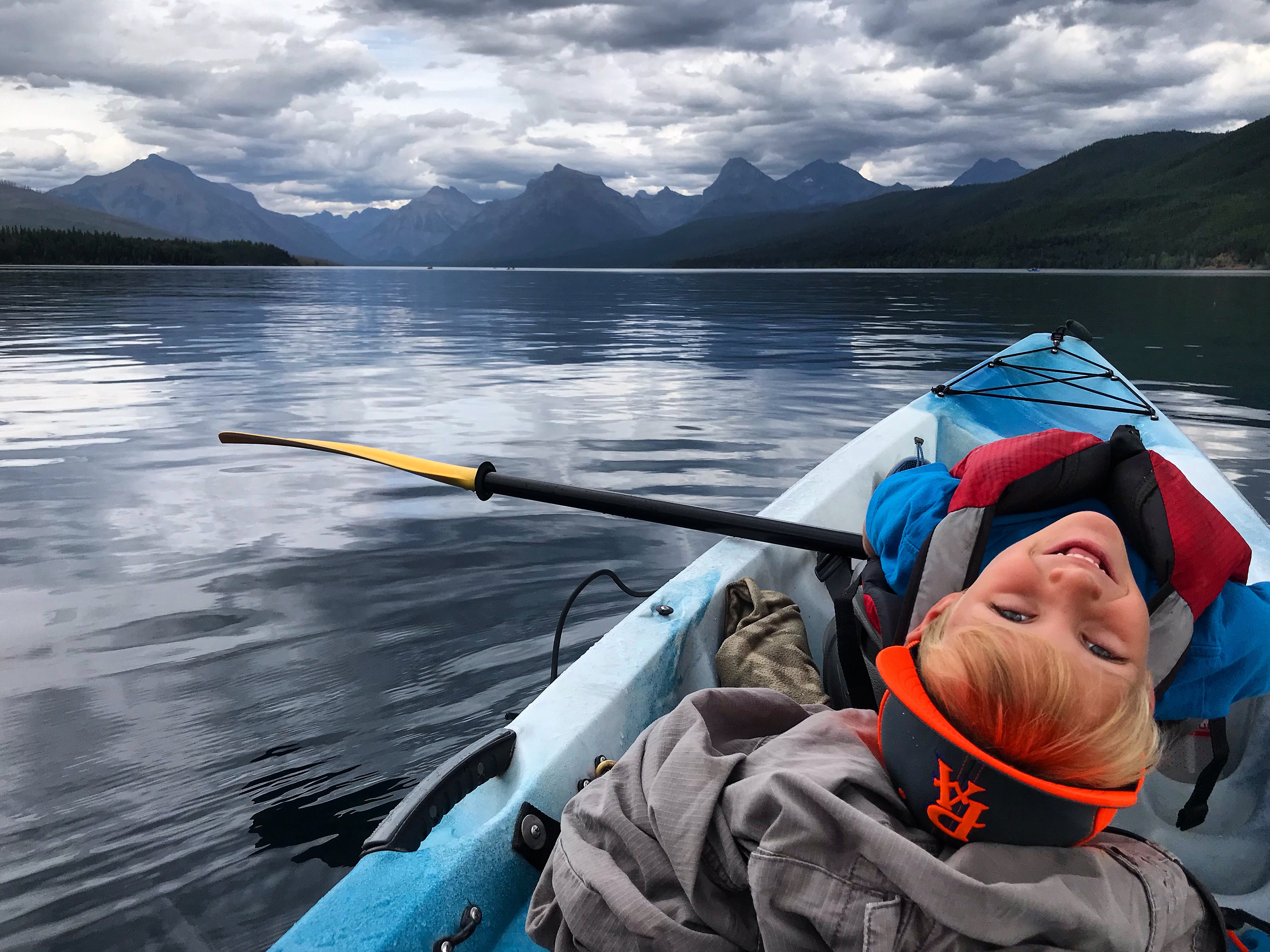 Boy in a canoe on a cloudy day