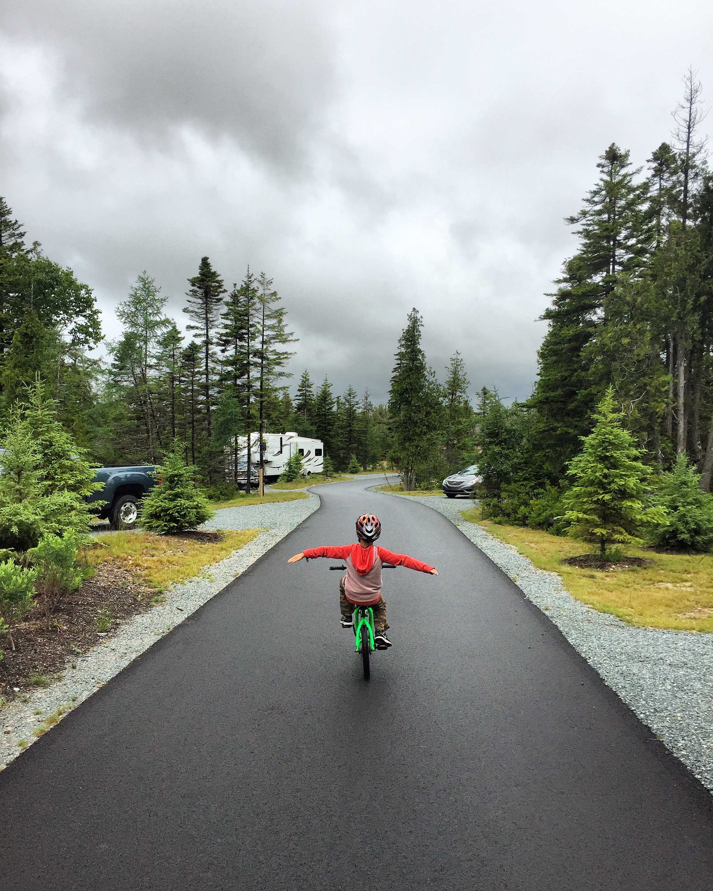 Child riding a bike on a cloudy day