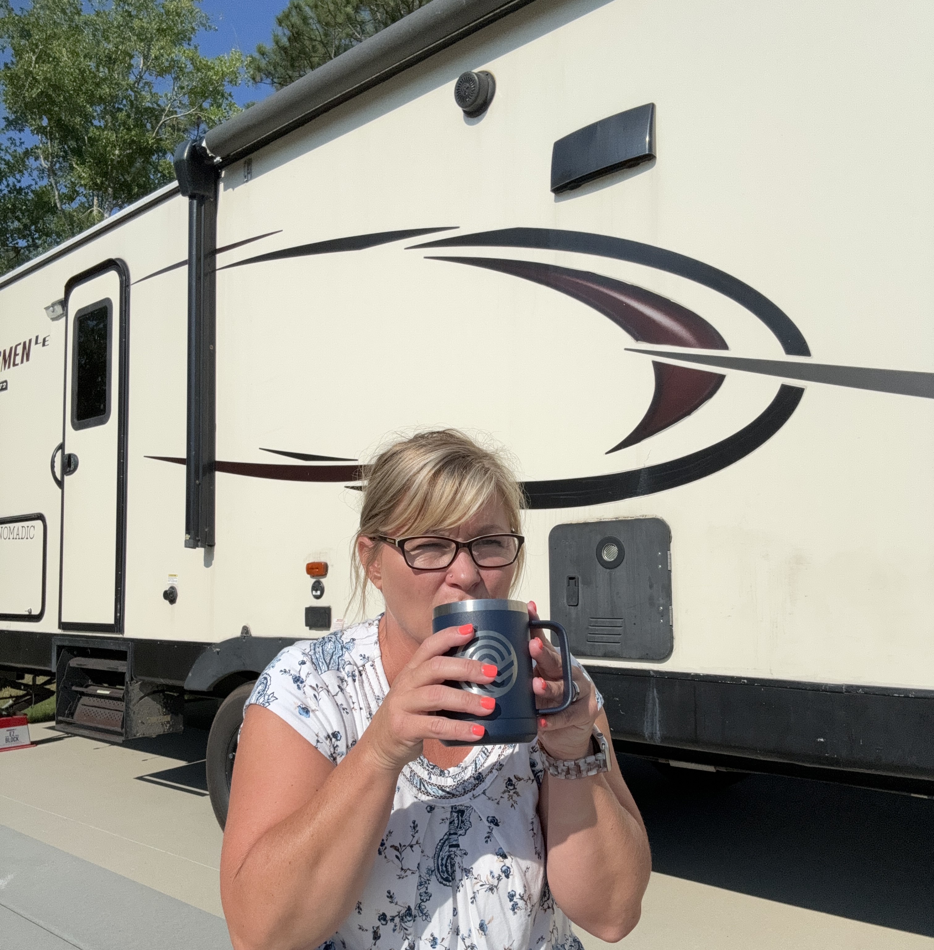 Drinking coffee in front of the rv 