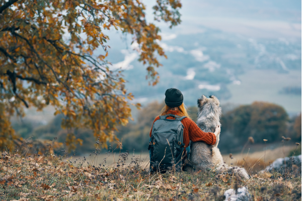 Lady and dog sitting on hill
