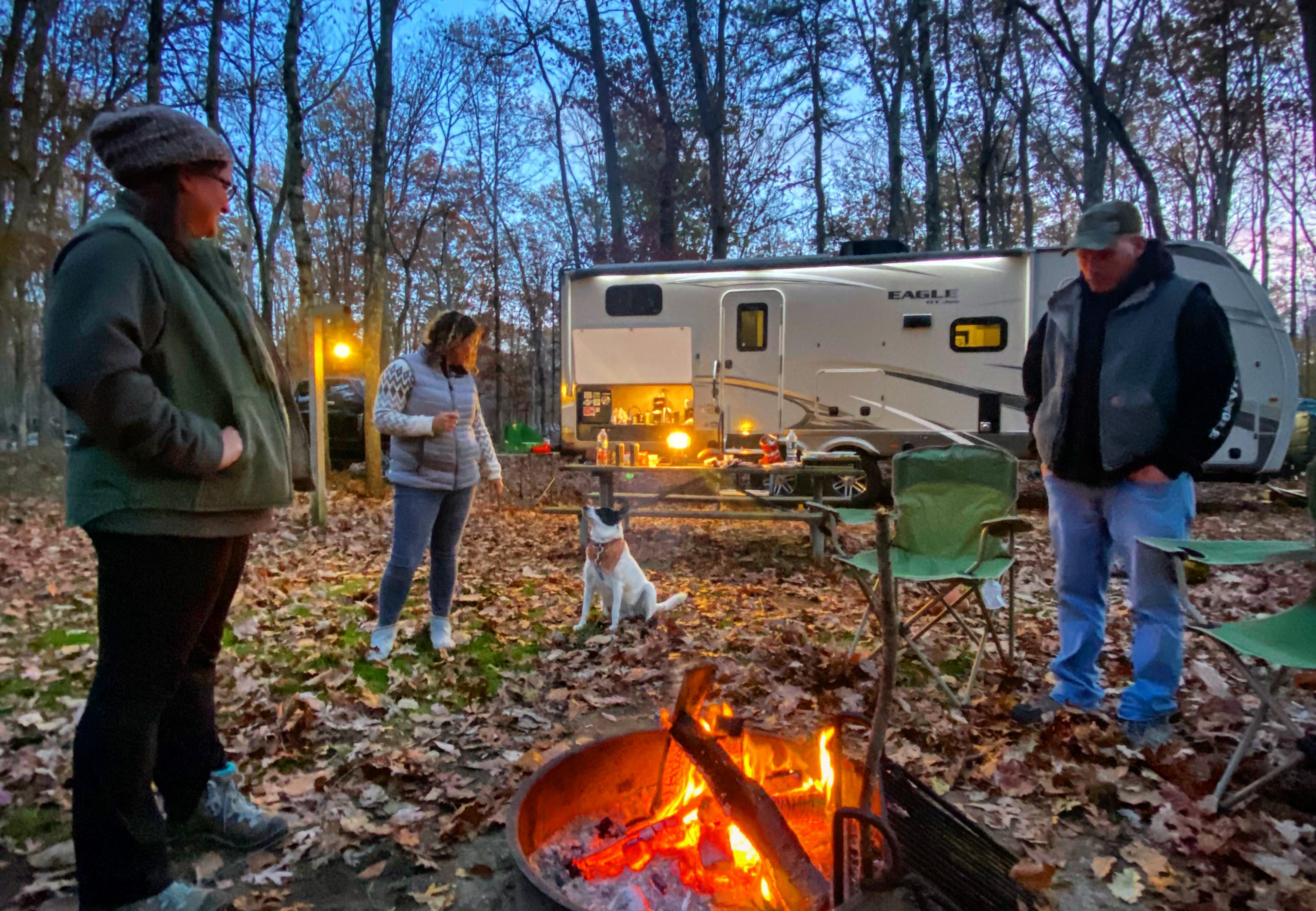 Lighting a campfire at night at RV site