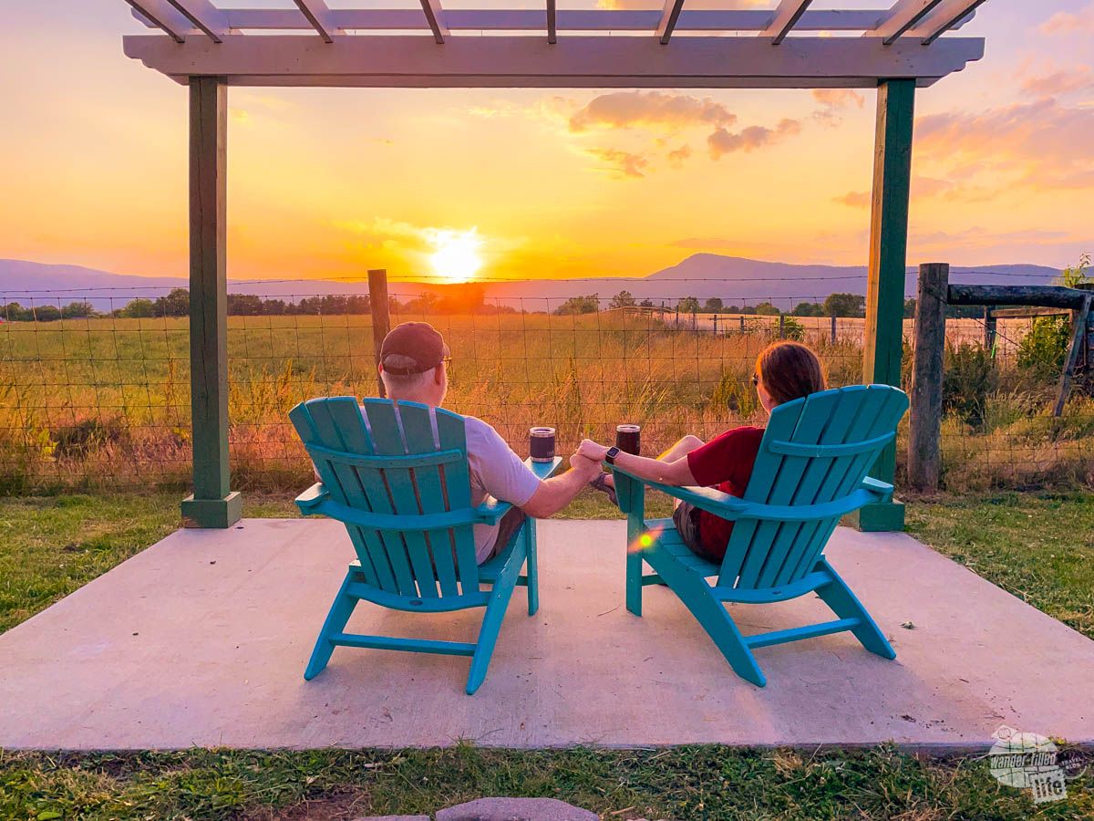 People relaxing with mountain view at sunset