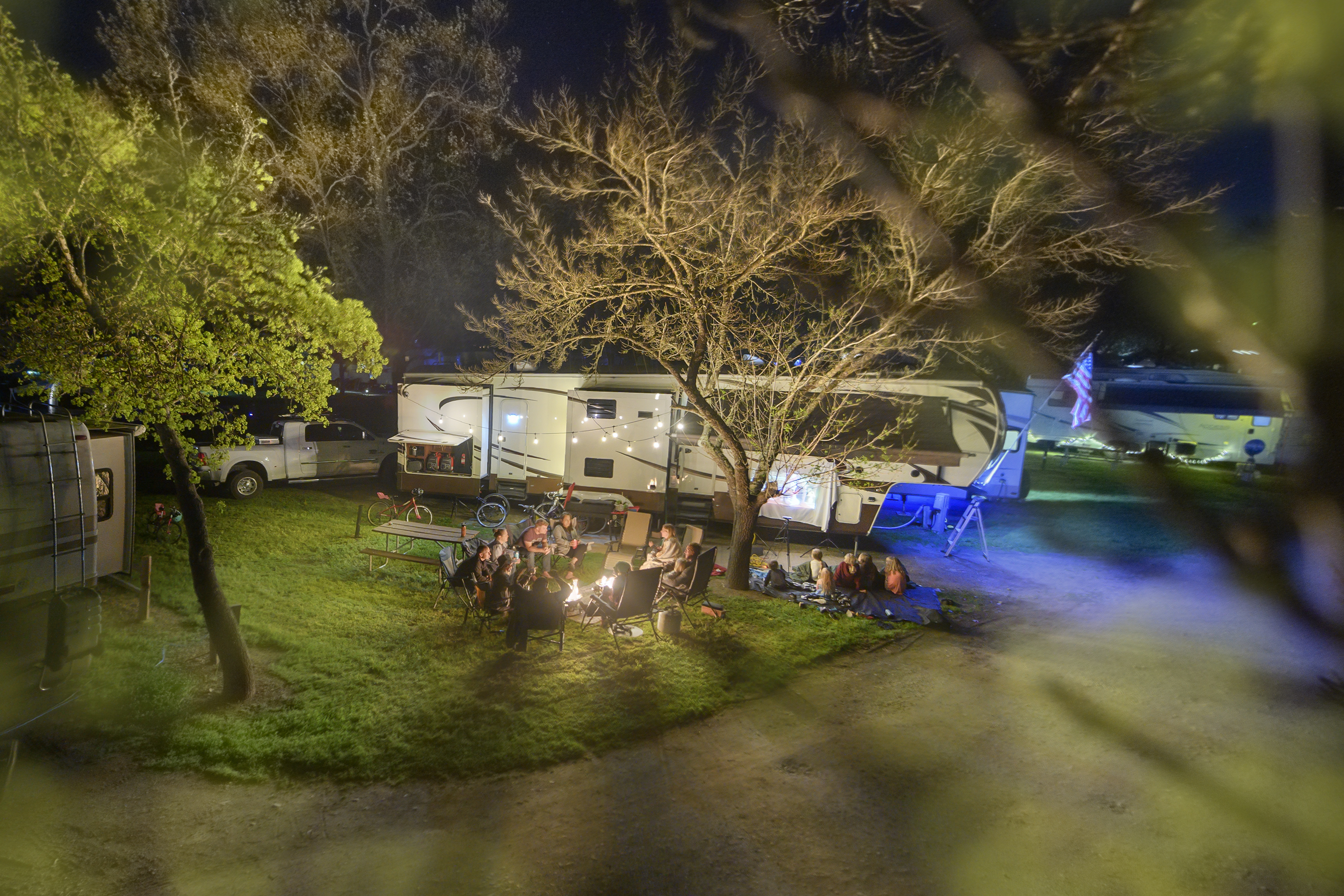 RV parked at night among trees