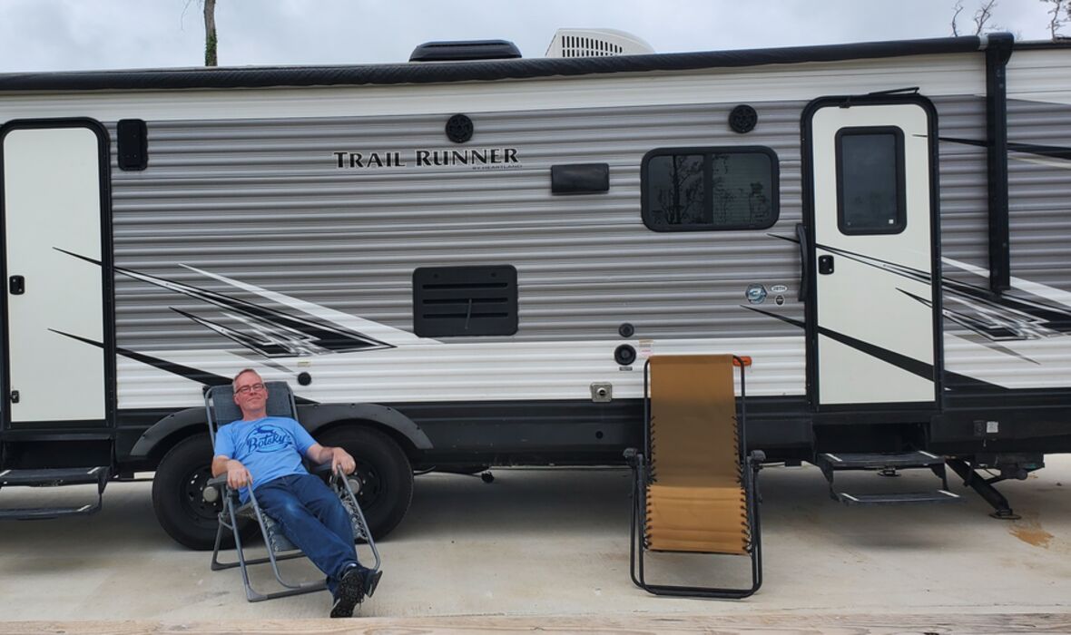 relaxing in front of RV at campsite
