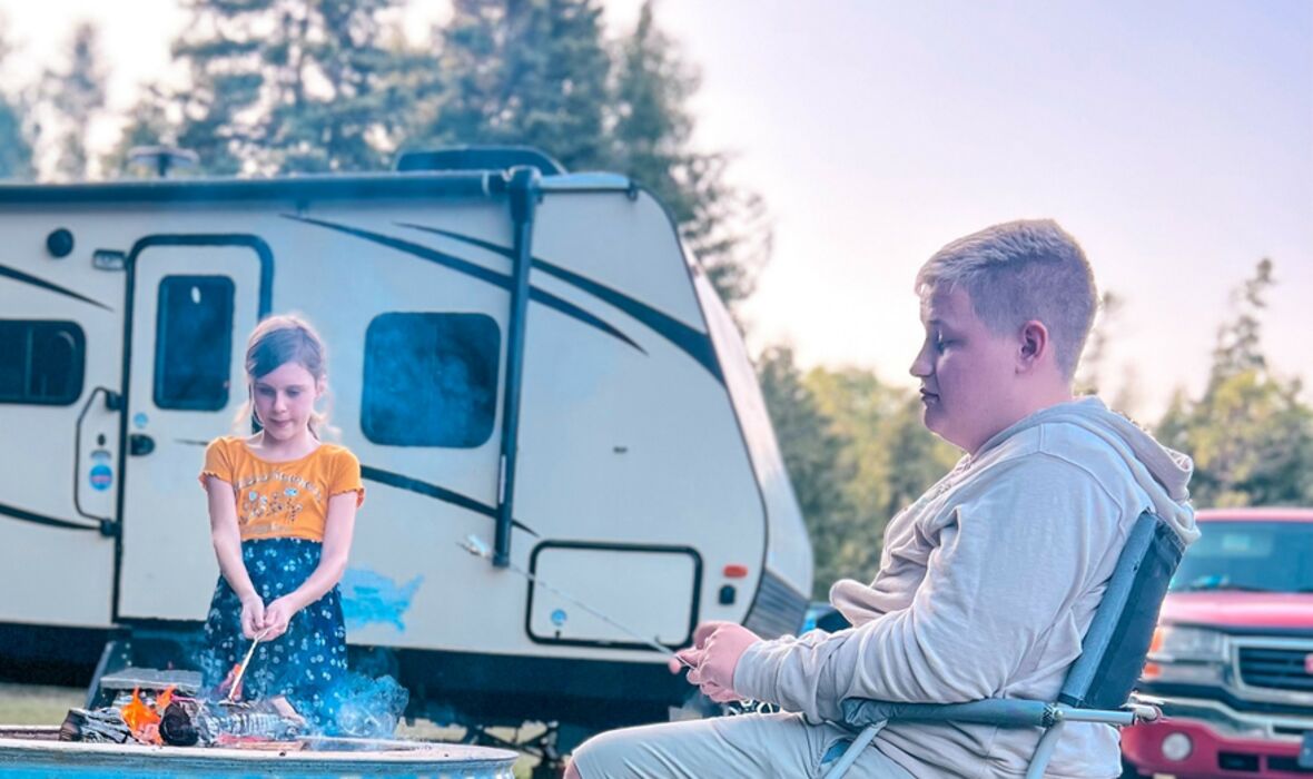 Kids sitting in front of RV