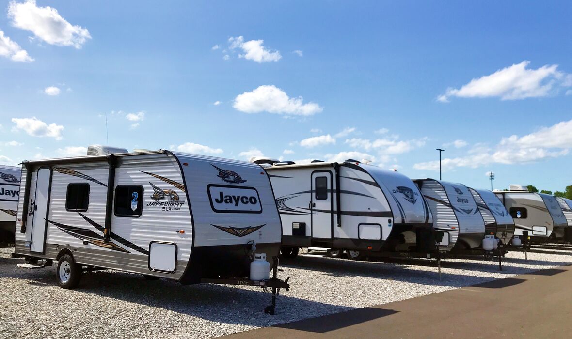 Travel trailers at a dealership on a sunny day