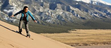 man snowboarding on sand