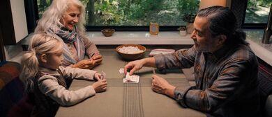 couple playing cards with granddaughter