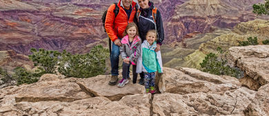 Braga family standing on a mountain cliff