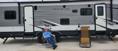 relaxing in front of RV at campsite