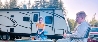 Kids sitting in front of RV