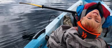 Boy in a canoe on a cloudy day