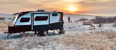 Travel trailer on beach at sunset