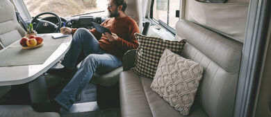 Man looking at tablet in his RV