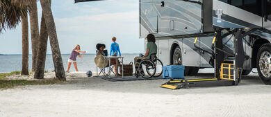 People gathered next to accessible RV on the beach