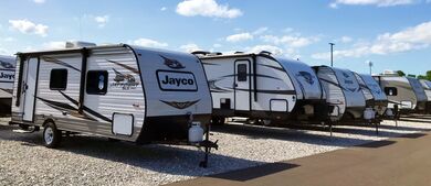 Travel trailers at a dealership on a sunny day