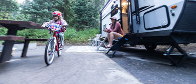 Child Biking Outside Travel Trailer