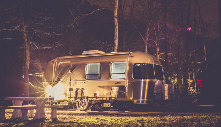 towable rv outside at night
