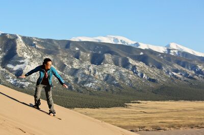 man snowboarding on sand