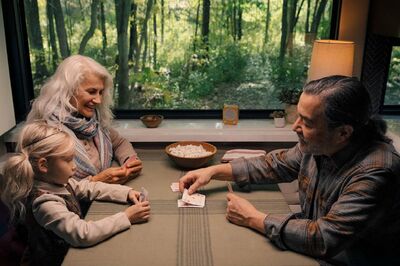 couple playing cards with granddaughter