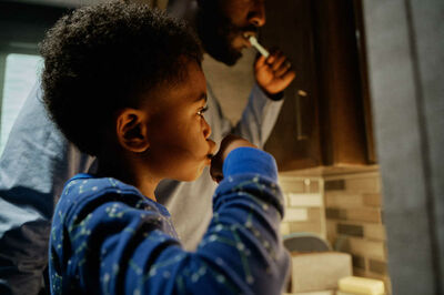 Father and son brushing teeth