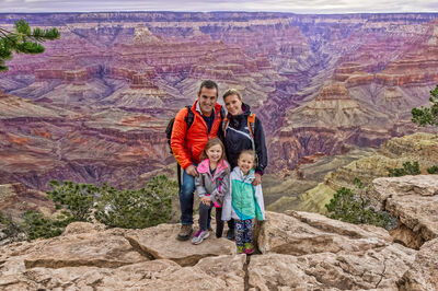 Braga family standing on a mountain cliff