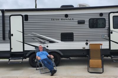 relaxing in front of RV at campsite