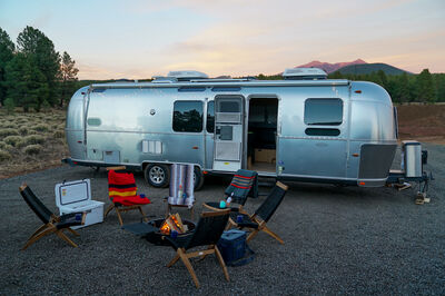 Airstream parked outside at a campsite