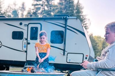 Kids sitting in front of RV