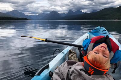 Boy in a canoe on a cloudy day