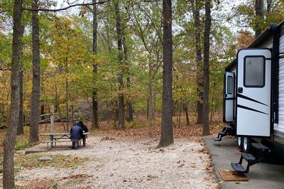 RV sitting in woods in the fall