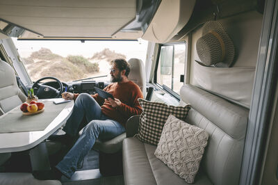 Man looking at tablet in his RV