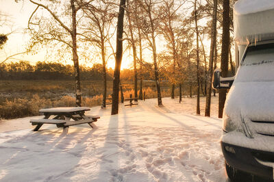RV in the snow during the daytime