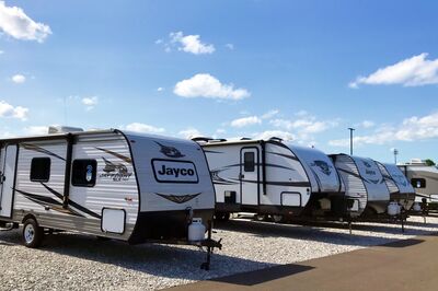 Travel trailers at a dealership on a sunny day