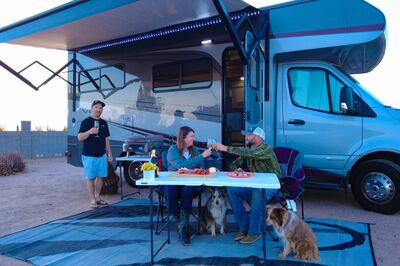 People with their dogs next to their Class C