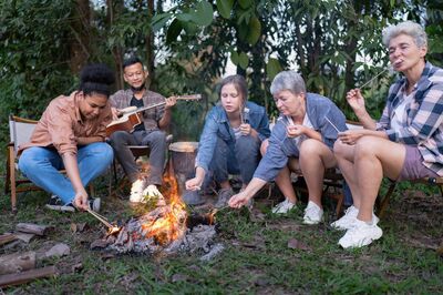 Individuals gathered around a campfire