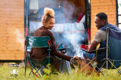 Two people with their dog at a campground 