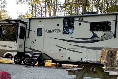 Fifth wheel next to campfire