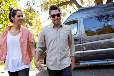 Couple exiting Class B campervan_h