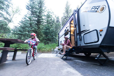 Child Biking Outside Travel Trailer