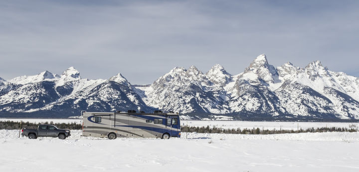Class A RV with snowy mountain