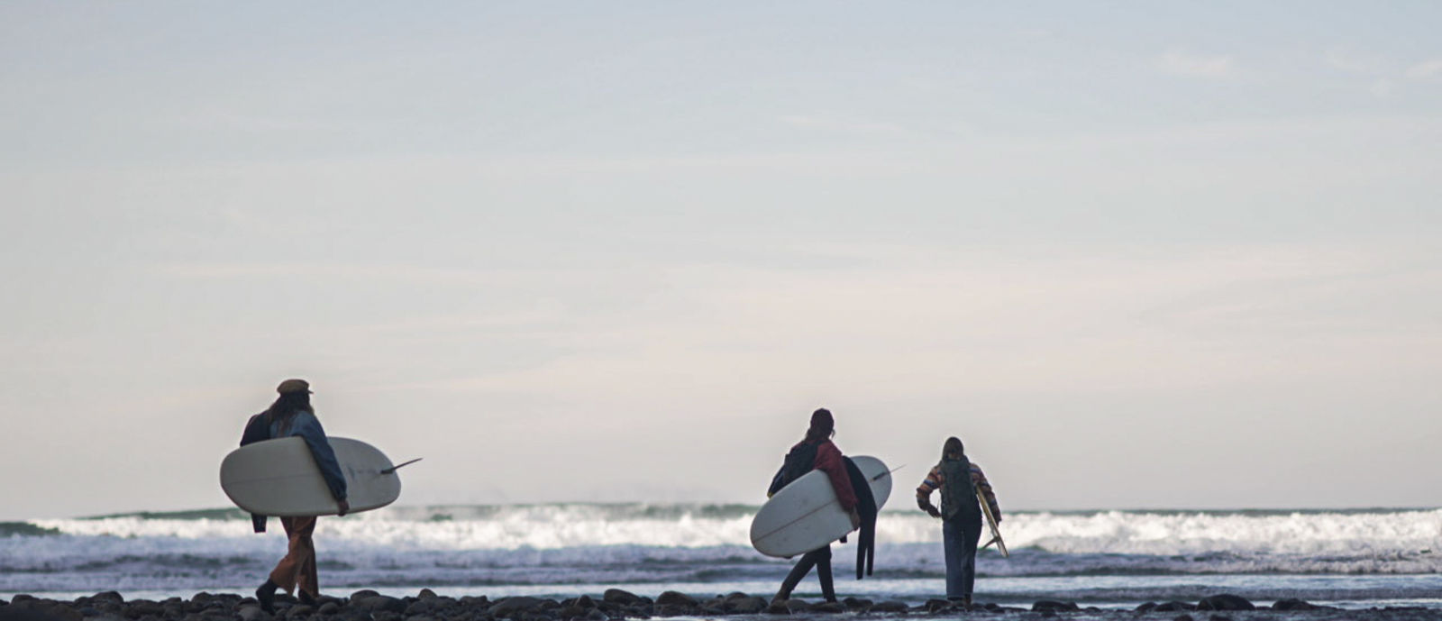 3 women with surfboards