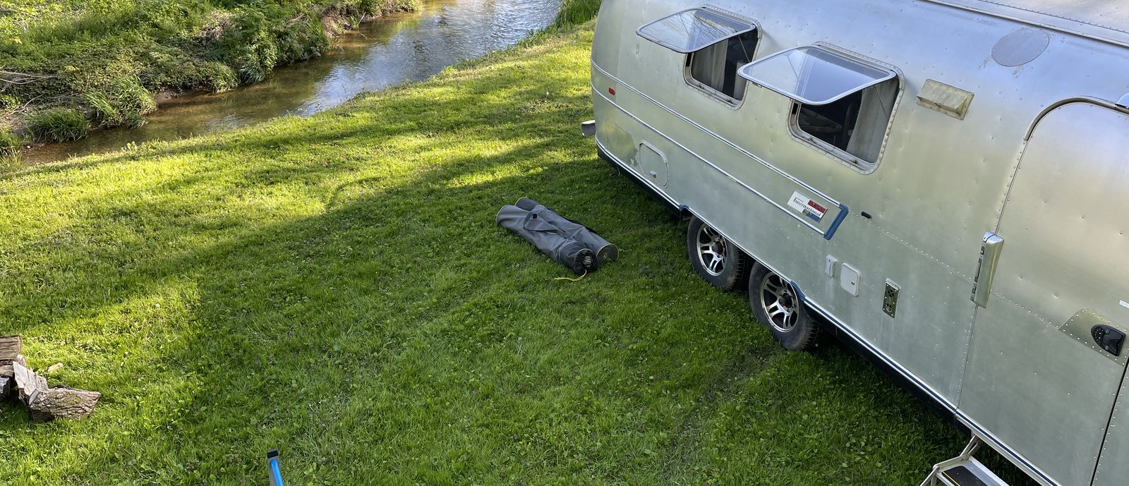 airstream boondocking by creek