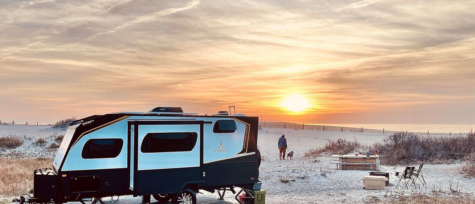 travel trailer on the beach with sunset