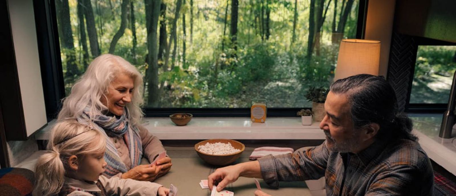 couple playing cards with granddaughter
