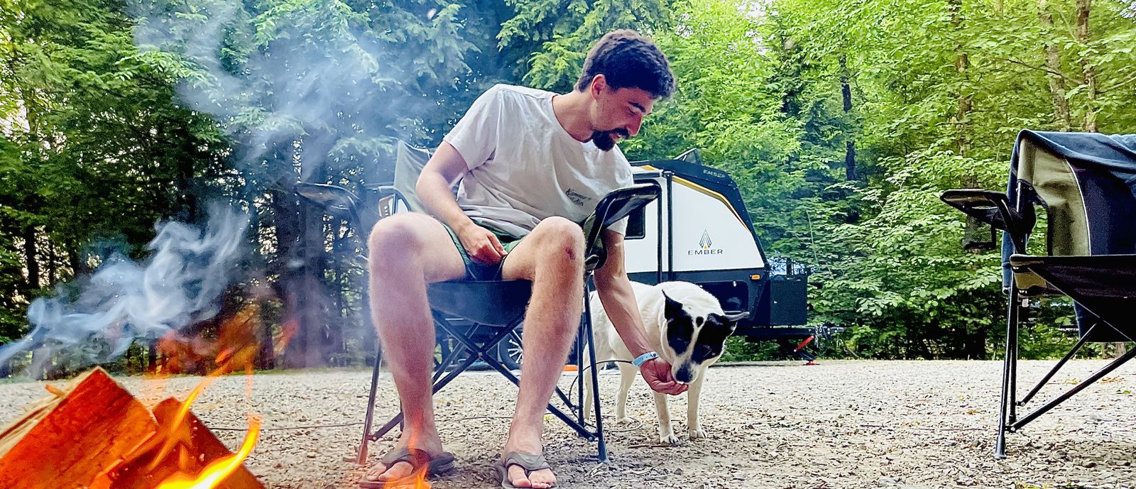 man at fire feeding dog