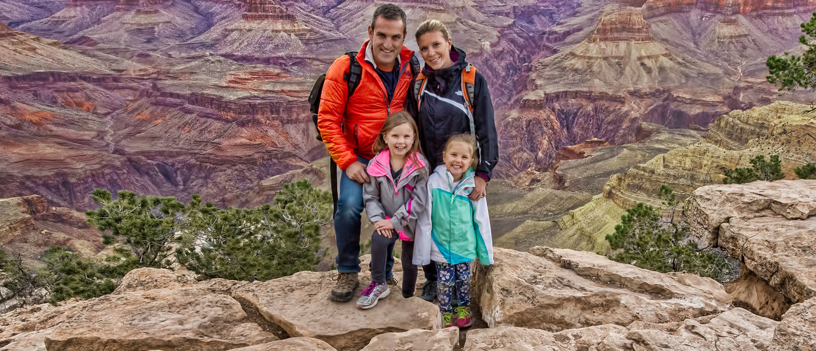 Braga family standing on a mountain cliff