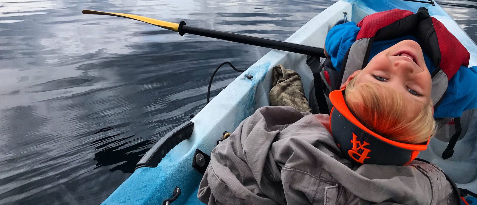 Boy in a canoe on a cloudy day