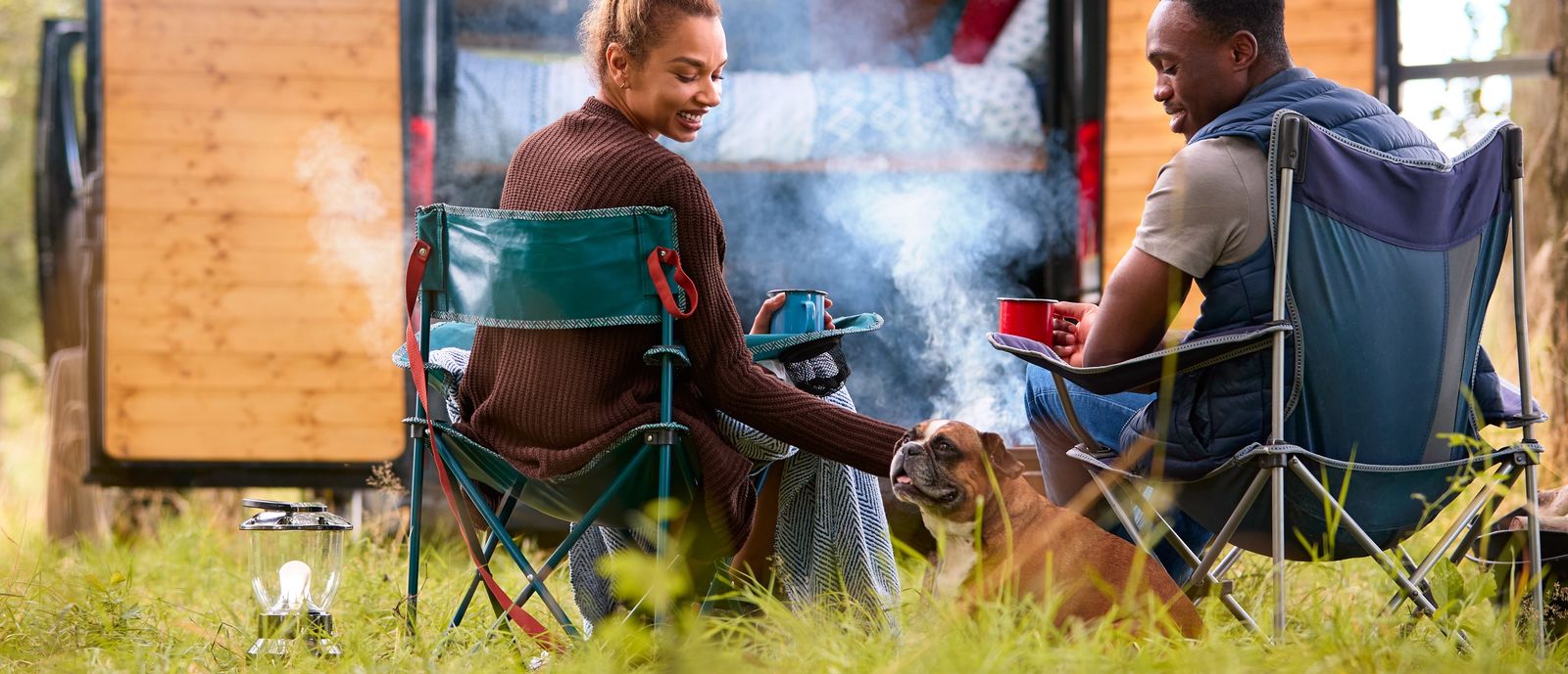 Two people with their dog at a campground 